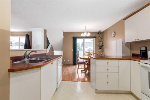 168 Mt Apex Green Se, Calgary, AB - Indoor Photo Showing Kitchen With Double Sink
