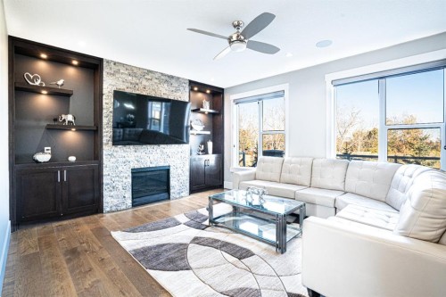 321 Kinniburgh Cove, Chestermere, AB - Indoor Photo Showing Living Room With Fireplace