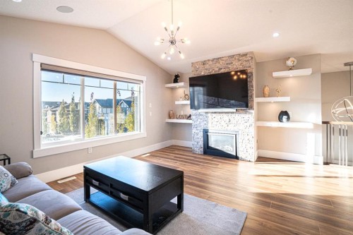 321 Kinniburgh Cove, Chestermere, AB - Indoor Photo Showing Living Room With Fireplace