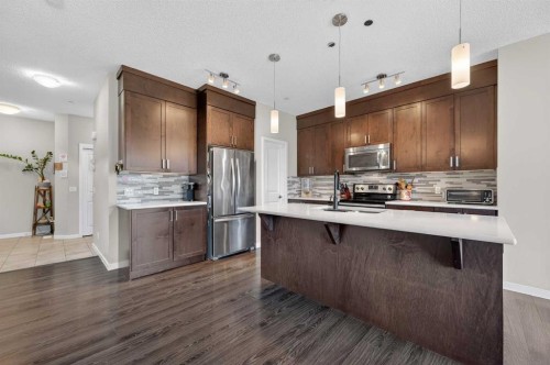 15 Fireside Crescent, Cochrane, AB - Indoor Photo Showing Kitchen With Upgraded Kitchen