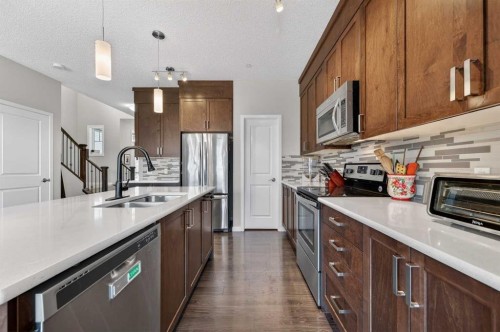 15 Fireside Crescent, Cochrane, AB - Indoor Photo Showing Kitchen With Double Sink With Upgraded Kitchen