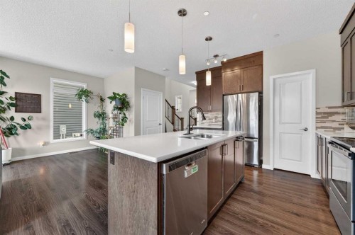 15 Fireside Crescent, Cochrane, AB - Indoor Photo Showing Kitchen With Double Sink With Upgraded Kitchen