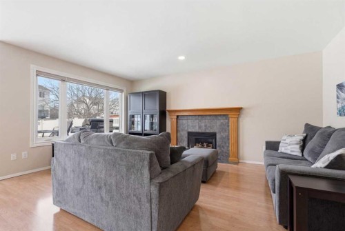1067 Coventry Drive Ne, Calgary, AB - Indoor Photo Showing Living Room With Fireplace