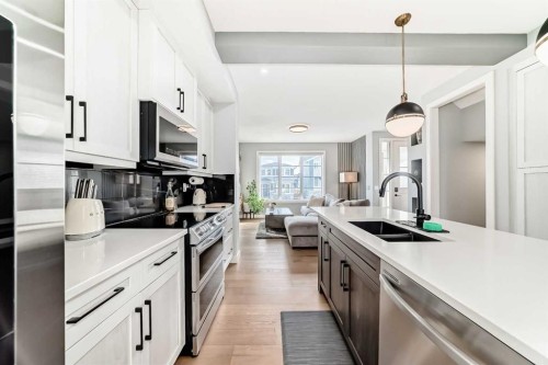 29 Precedence Glen, Cochrane, AB - Indoor Photo Showing Kitchen With Double Sink With Upgraded Kitchen