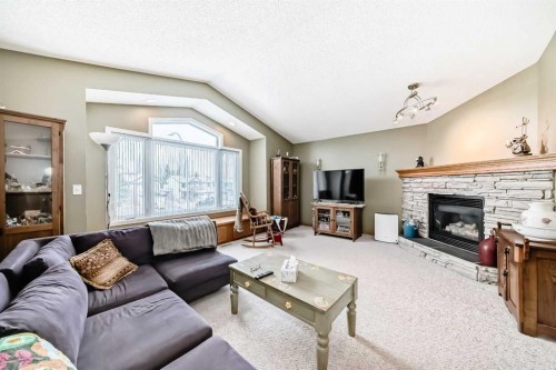 199 Mt Brewster Circle Se, Calgary, AB - Indoor Photo Showing Living Room With Fireplace