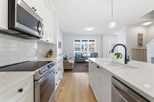 359 Fireside Way, Cochrane, AB - Indoor Photo Showing Kitchen With Double Sink With Upgraded Kitchen
