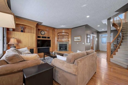 151 Arbour Vista Road Nw, Calgary, AB - Indoor Photo Showing Living Room With Fireplace