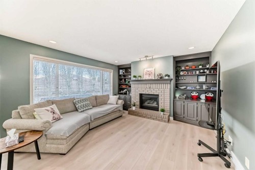 668 Scimitar Bay Nw, Calgary, AB - Indoor Photo Showing Living Room With Fireplace