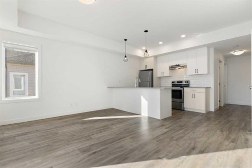 602-24 Rivercrest Drive, Cochrane, AB - Indoor Photo Showing Kitchen With Upgraded Kitchen