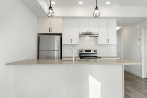 602-24 Rivercrest Drive, Cochrane, AB - Indoor Photo Showing Kitchen With Upgraded Kitchen