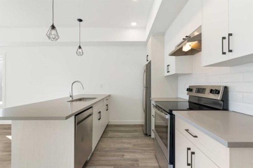 602-24 Rivercrest Drive, Cochrane, AB - Indoor Photo Showing Kitchen With Upgraded Kitchen
