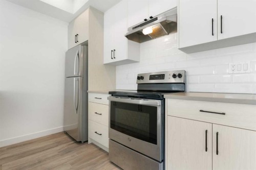 602-24 Rivercrest Drive, Cochrane, AB - Indoor Photo Showing Kitchen With Upgraded Kitchen