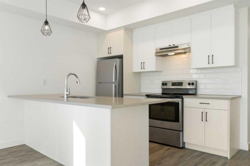 602-24 Rivercrest Drive, Cochrane, AB - Indoor Photo Showing Kitchen With Upgraded Kitchen