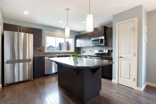 31 Sunset Link, Cochrane, AB - Indoor Photo Showing Kitchen With Double Sink With Upgraded Kitchen