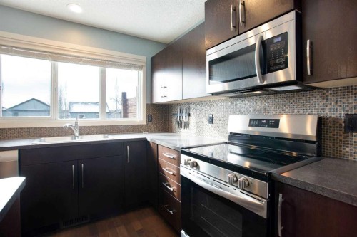 31 Sunset Link, Cochrane, AB - Indoor Photo Showing Kitchen With Double Sink