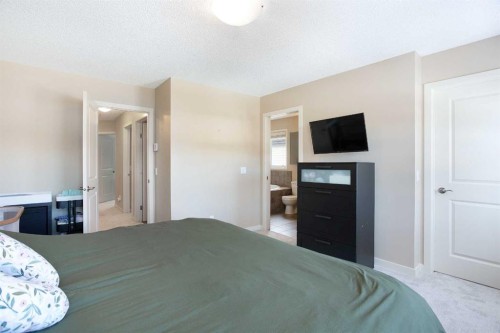 31 Sunset Link, Cochrane, AB - Indoor Photo Showing Bedroom
