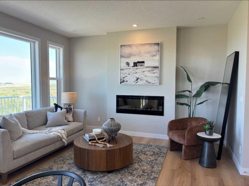 30 Bridges Way, Langdon, AB - Indoor Photo Showing Living Room With Fireplace