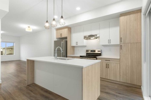 103-24 Rivercrest Drive, Cochrane, AB - Indoor Photo Showing Kitchen With Stainless Steel Kitchen With Upgraded Kitchen