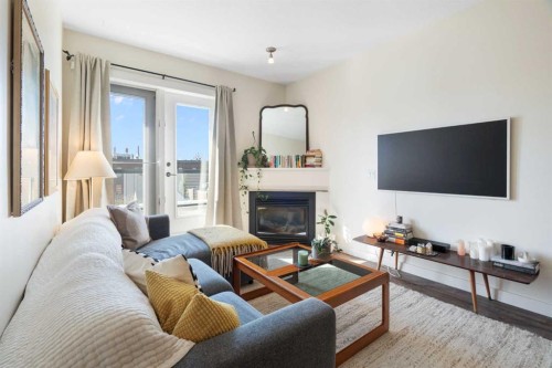 406-830 Centre Avenue Ne, Calgary, AB - Indoor Photo Showing Living Room With Fireplace