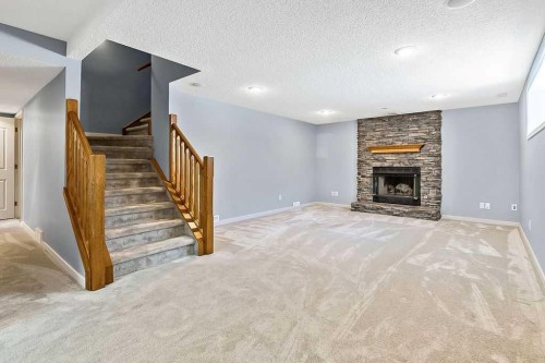 303 Schubert Place Nw, Calgary, AB - Indoor Photo Showing Living Room With Fireplace