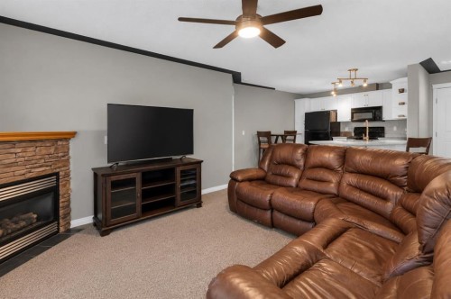 203-345 Rocky Vista Park Nw, Calgary, AB - Indoor Photo Showing Living Room With Fireplace