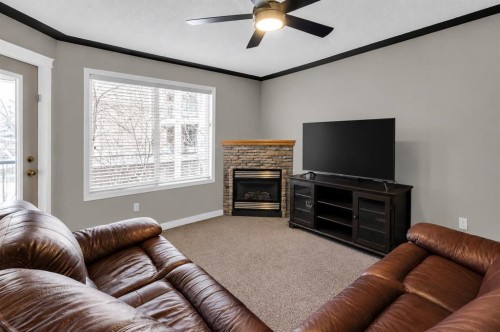 203-345 Rocky Vista Park Nw, Calgary, AB - Indoor Photo Showing Living Room With Fireplace