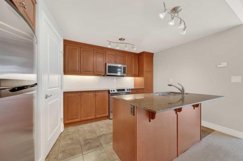 1402-910 5 Avenue Sw, Calgary, AB - Indoor Photo Showing Kitchen With Stainless Steel Kitchen