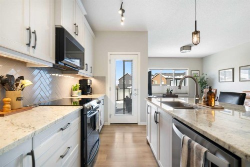 46 Emberside Place, Cochrane, AB - Indoor Photo Showing Kitchen With Double Sink With Upgraded Kitchen