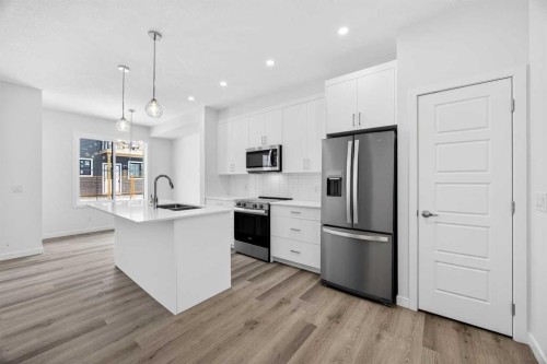 66 Creekside Way Sw, Calgary, AB - Indoor Photo Showing Kitchen With Stainless Steel Kitchen With Double Sink With Upgraded Kitchen
