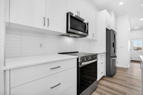 66 Creekside Way Sw, Calgary, AB - Indoor Photo Showing Kitchen With Stainless Steel Kitchen With Upgraded Kitchen
