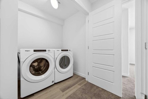 66 Creekside Way Sw, Calgary, AB - Indoor Photo Showing Laundry Room