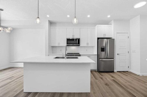 66 Creekside Way Sw, Calgary, AB - Indoor Photo Showing Kitchen With Stainless Steel Kitchen With Double Sink With Upgraded Kitchen