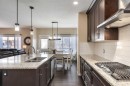 26 Mount Rae Terrace, Okotoks, AB  - Indoor Photo Showing Kitchen With Double Sink With Upgraded Kitchen 