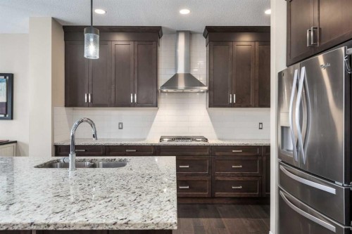 26 Mount Rae Terrace, Okotoks, AB - Indoor Photo Showing Kitchen With Double Sink With Upgraded Kitchen