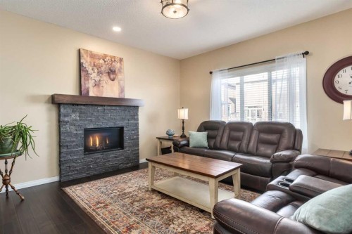 26 Mount Rae Terrace, Okotoks, AB - Indoor Photo Showing Living Room With Fireplace
