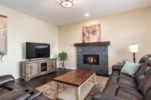 26 Mount Rae Terrace, Okotoks, AB - Indoor Photo Showing Living Room With Fireplace