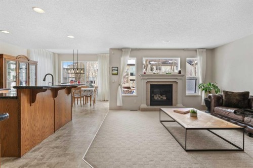 98 Cougarstone Close Sw, Calgary, AB - Indoor Photo Showing Living Room With Fireplace