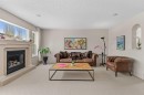 98 Cougarstone Close Sw, Calgary, AB  - Indoor Photo Showing Living Room With Fireplace 