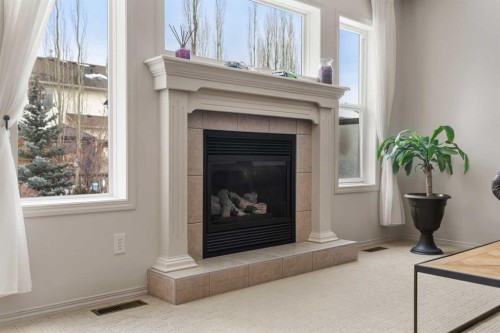 98 Cougarstone Close Sw, Calgary, AB - Indoor With Fireplace