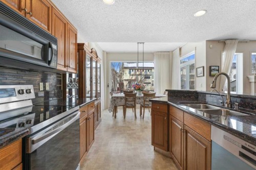 98 Cougarstone Close Sw, Calgary, AB - Indoor Photo Showing Kitchen With Double Sink