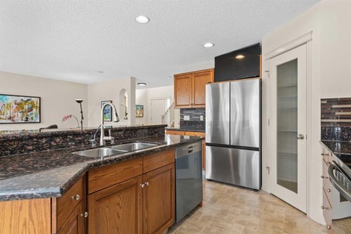 98 Cougarstone Close Sw, Calgary, AB - Indoor Photo Showing Kitchen With Stainless Steel Kitchen With Double Sink