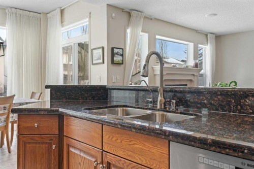 98 Cougarstone Close Sw, Calgary, AB - Indoor Photo Showing Kitchen With Double Sink