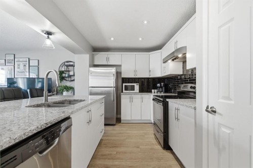 405 Windstone Grove Sw, Airdrie, AB - Indoor Photo Showing Kitchen With Stainless Steel Kitchen With Double Sink With Upgraded Kitchen