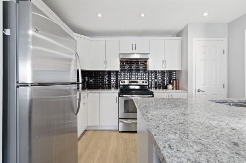 405 Windstone Grove Sw, Airdrie, AB - Indoor Photo Showing Kitchen With Stainless Steel Kitchen With Upgraded Kitchen