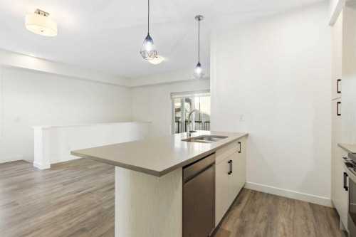 404-24 Rivercrest Drive, Cochrane, AB - Indoor Photo Showing Kitchen With Double Sink