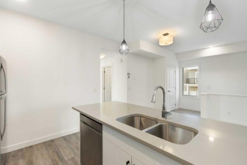 404-24 Rivercrest Drive, Cochrane, AB - Indoor Photo Showing Kitchen With Double Sink