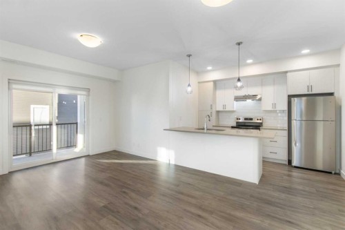 404-24 Rivercrest Drive, Cochrane, AB - Indoor Photo Showing Kitchen With Double Sink With Upgraded Kitchen