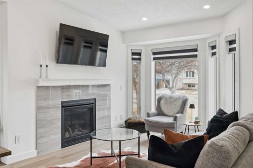 194 Martinglen Way Ne, Calgary, AB - Indoor Photo Showing Living Room With Fireplace