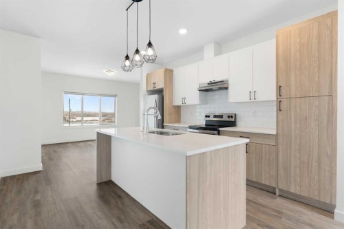 1701-24 Rivercrest Drive, Cochrane, AB - Indoor Photo Showing Kitchen With Stainless Steel Kitchen With Double Sink With Upgraded Kitchen