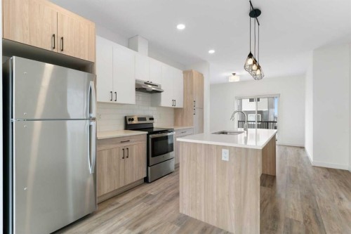 1701-24 Rivercrest Drive, Cochrane, AB - Indoor Photo Showing Kitchen With Stainless Steel Kitchen With Upgraded Kitchen